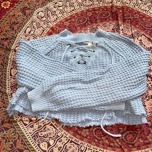 Cropped knit sweater.